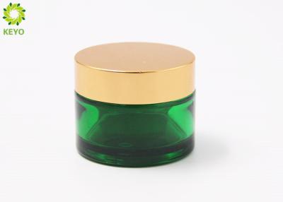 China Tipo ancho de la boca de los envases cosméticos vacíos verdes del vidrio esmerilado con el casquillo plástico de oro en venta