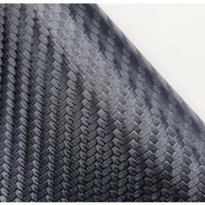 China Cuero de PVC negro resistente a la llama de 0,6 mm de fibra de carbono en relieve en venta