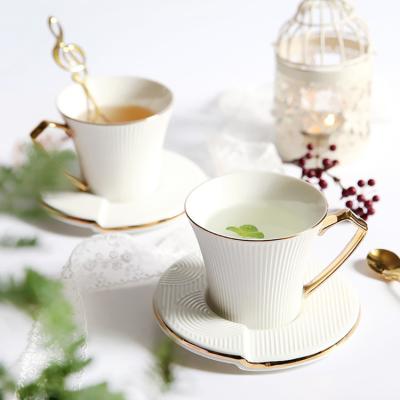 China Custom Afternoon Drinkware Luxury Gold Plated Ceramic Cup with Saucer Wholesale Modern Irregular Coffee Tea Cups for sale