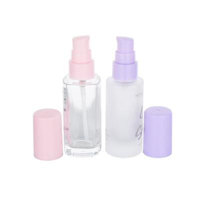China 30ml Transparent Empty Foundation Bottle With Pink Or Purple Plastic Caps for sale