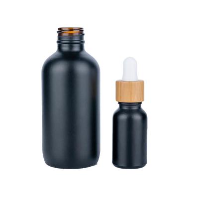 China Round Matte Black Cosmetic Dropper Bottles For Essential Oil 28.9mm for sale