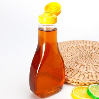 China Material plástico del animal doméstico de la botella de la miel del apretón de la categoría alimenticia con la válvula del silicón en venta
