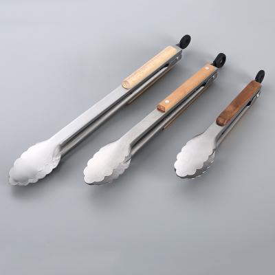 China Heat Resistant Kitchen Food Tongs Stainless Steel Wood Handle Barbecue Food Clip for sale