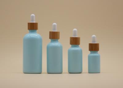 China Color Coating Sky Blue 15ml 30ml Essential Oil Bottles With Bamboo Dropper for sale