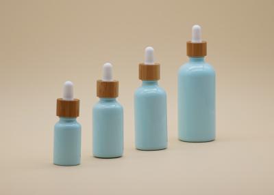 China Garrafas de vidro azuis de óleo essencial da cor das amostras grátis com conta-gotas de bambu à venda