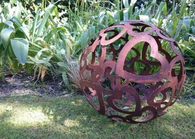China Large Heart Pattern Corten Steel Sculpture Hollow Sphere Metal Garden Ball for sale