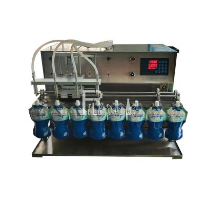 China Semi Automatic Stand Up Pouch Water Filling Machine Desktop 10 Nozzles Juice Milk for sale