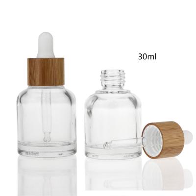 China 20ml 30ml 50ml Cosmetic Skincare Glass Serum Bottle With Texture Bamboo Collar Cap Glass Dropper Bottle for sale