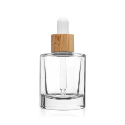 China Botella de cristal clara de empaquetado cosmética del dropper del suero de la cara con la tapa de bambú en venta