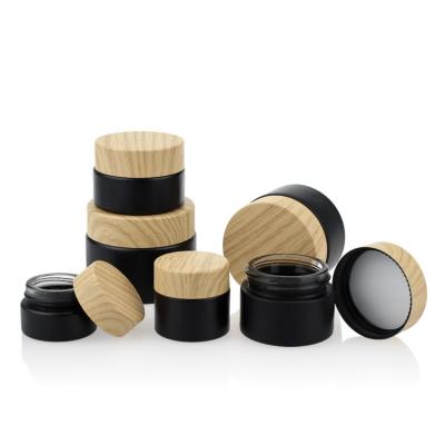 China Cosmetic Packaging Set Bamboo Color Screw Cap Black Matte Glass Jars 50g for sale
