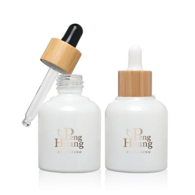 China Cosmetic Serum Essential Oil Glass Bottle 30ml Empty Bamboo Dropper for sale
