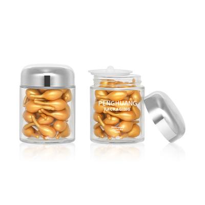 China Round 100g Capsule Glass Container With Rose Golden Cap Sliver Cap Glass Jar Packaing for sale