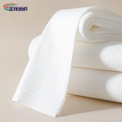 中国 30x70cm使い捨て可能なRagsの布の白いSpunlaceのNonwoven 80GSM使い捨て可能な毛タオル 販売のため