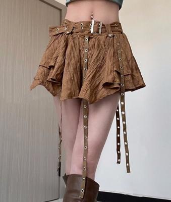 中国 小さい順序の女性の不規則なスカートのジッパーのブラウンのベルトが付いている低いウエストのスカートのための衣料メーカー 販売のため