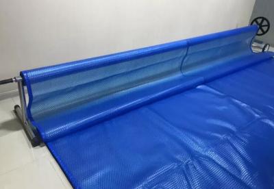 China 9M * 15M Swimming Pool Solar Cover Anti - UV Waterproof Heat Retention Automatic Swimming Pool Cover for sale