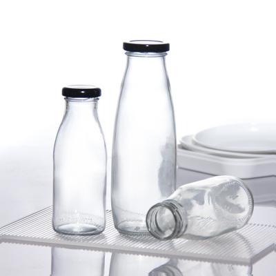 China OEM 1000ml 2 Litre Glass Milk Bottles Jug Food Grade Round Shape for sale