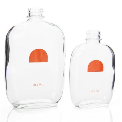 China Custom 50ml 200ml Small Glass Juice Bottles Flat With Screw Lid for sale
