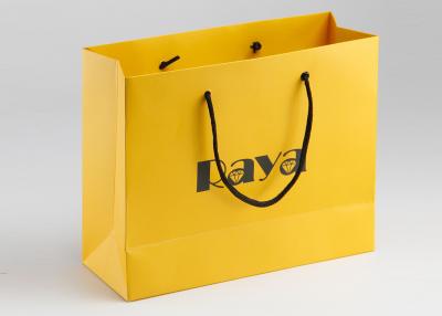 China Yellow Matte Paper Shopping Bags Nylon Handle And Customized Logo Printed for sale