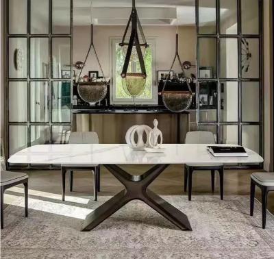 China Mesa de jantar de cerâmica de mármore branco intemporal, mesa de jantar com base de aço em forma de X à venda