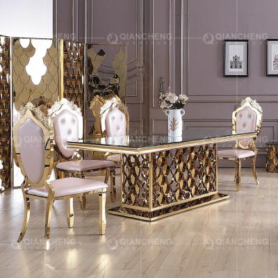 China Qiancheng ODM Tempered Glass Dining Table Golden Stainless Steel For Wedding for sale