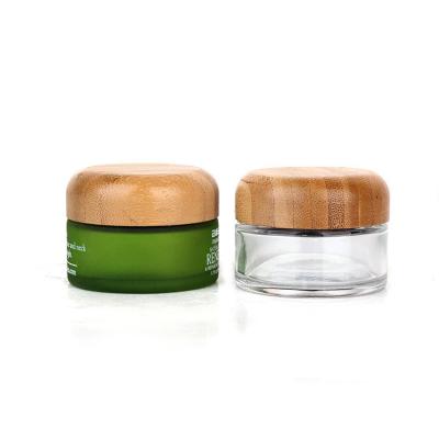 China Cream bottle with bamboo lid, cosmetic packaging material, round thick transparent glass cream bottle, 50g container for sale