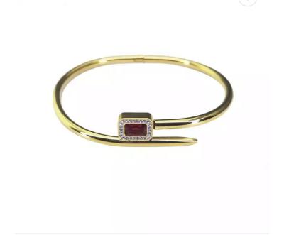 China Luxury Red Ruby Diamond Studded Nail Bracelet 24k Gold Stainless Steel Bangle for sale
