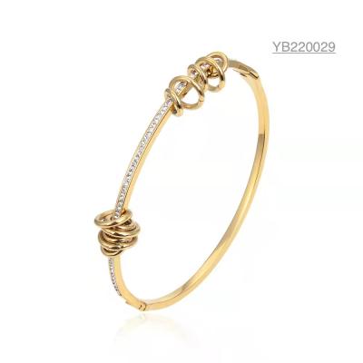 China unique niche brand coil rhinestone inlaid bracelets 18k gold snap button bangles for sale