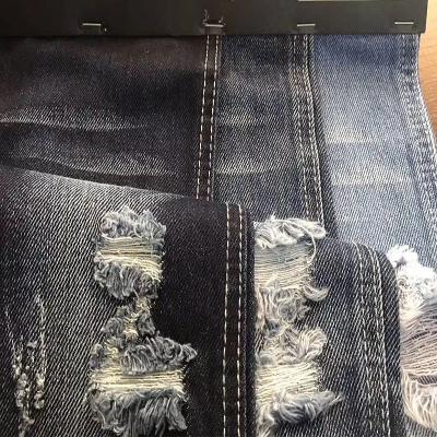 China Vintage Hole Ripped Washed Cotton Polyester Spandex Denim Fabric for sale