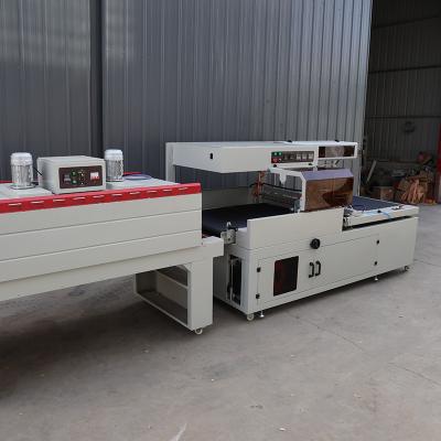 China Stainless Steel Plastic Wrap Packaging Machine Pneumatic Shrink Packing Machine for sale