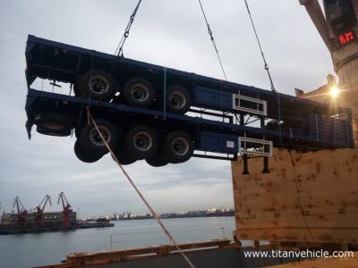 China 50 ton low price tri axle flatbed trailer with side bars - TITAN VEHICLE en venta
