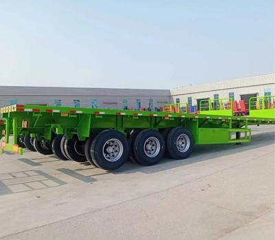 中国 Q345B Semi Flatbed Trailer For Hauling Cargo Side Wall Removable Or Fixed 24v Electrical System 販売のため