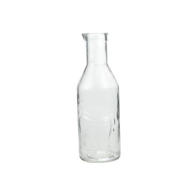 China Botellas de vidrio de leche de 1 litro Carafe en relieve diseñado con boca en venta