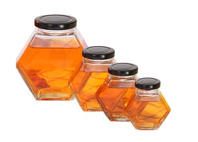 China 250ml-750ml Glass Honey Jars With Lids , Hexagon Glass Jars Clear Color for sale