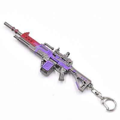 中国 Purple mini metal gun mold Key ring 1:6 authentic restoration of game props gun Ape x shoot game gun keychain 販売のため