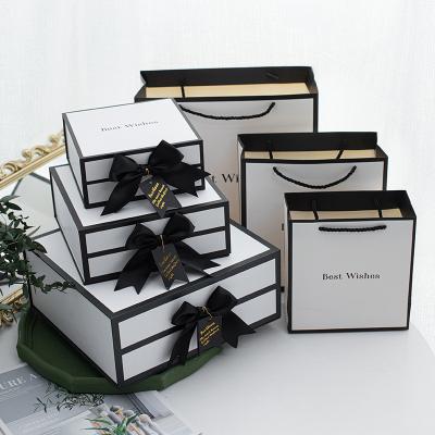 China Whole Sales Luxury Clothes Perfume Gift Set  Package Ribbon Bow Magnetic Closure Cardboard Folding Gift Box for sale