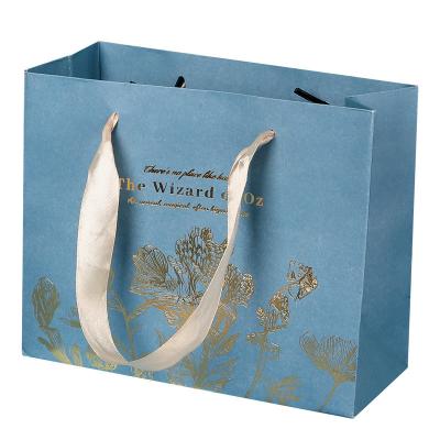 China Shopping Cardboard Clothing Packaging Kraft Paper Bags With Ribbon Handle for sale