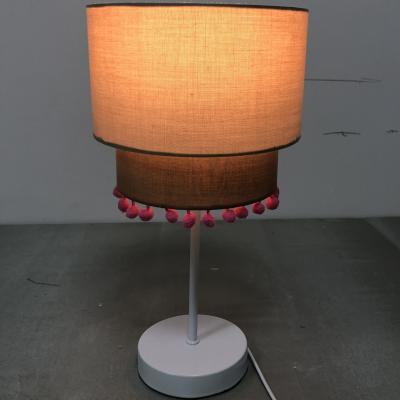 China TC Fabric Simple Modern Table Lamp Double Layer Linen Table Lamp With Pom Pom for sale