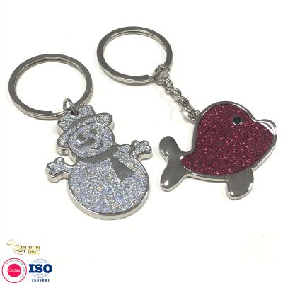 China Newest Custom Manufacturer Snowman Cute Gift Key Ring Silver Plated Charm Dolphin Animal Keychain with Glitter Te koop