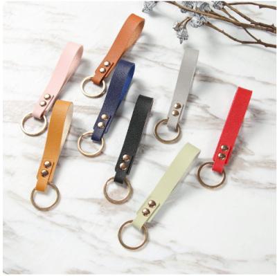China Custom Embossed Logo PU Leather Keychain Metal Strap Blank Solid Color Keyring for sale