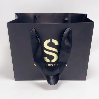 China Exquisite Black Kraft Paper Bag Silk Handle Custom Printed Paper Shopping Bags for sale