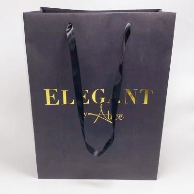 China Clothing Custom Printed Paper Bags Personalised Kraft Bags With Ribbon Handle for sale