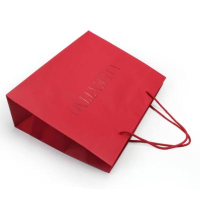 China 4C 6C Offset Printing Garment Paper Bags Dazzling Red Paper Gift Bags With Handles for sale