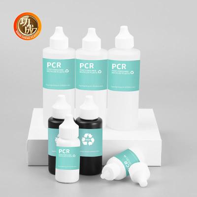 Chine Éco-friendly cosmétique Pcr plastique distribuant bouteilles de pressage avec torsion haut bouteilles d'huile capillaire Applicateur de buse à vendre