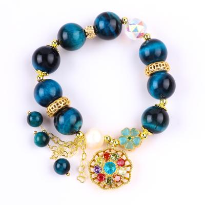China 14MM Energy Healing Crystal Blue Tiger Eye Flower Spinner Charm Bead Bracelet For Daily Wear for sale