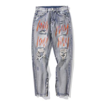 中国 OEMは落書きが付いている青い裂かれたジーンズの男女兼用のまっすぐな割れたズボンを洗浄した 販売のため
