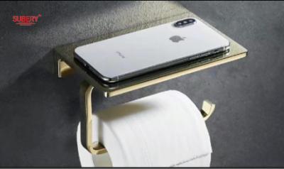 China Porta-papéis de higiene de zinco montado na parede porta-papéis de tecido porta-papéis de rolos de cor dourada com prateleira para telemóvel à venda