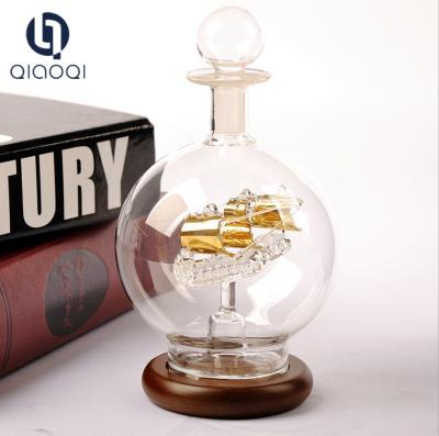 China Creative transparent glass sailing with wood base ship in bottle for sale