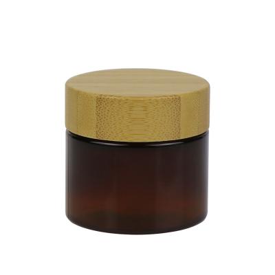 China Empty Cosmetic PET Cream Jar 50g 100g Plastic Container With Wooden Lid for sale