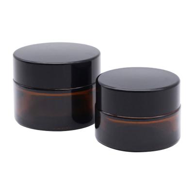 China 5g 20g 4oz 8oz Cosmetic Glass Jars Black Cap Amber Apothecary Jars for sale