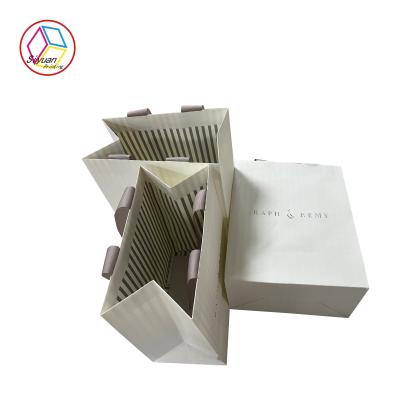 China Eco Friendly Silver Foil Logo Handmade Paper Bags With Ribbon for sale